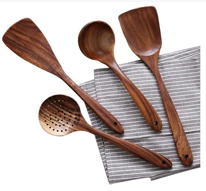 Cooking with natural wood utensils: a spatula, spoon, and other eco-friendly kitchen tools.