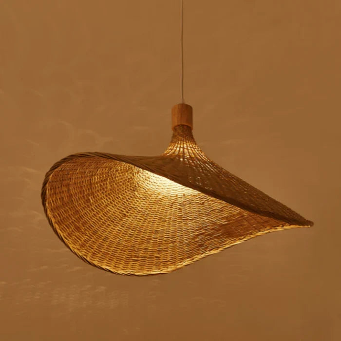 Elegant natural woven rattan pendant lamp illuminating a room. Perfect rustic bohemian ceiling light for a cozy ambiance.