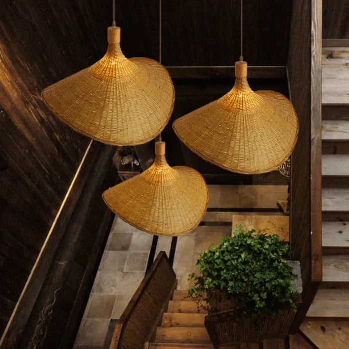 Unique bell-shaped natural woven rattan pendant lamp. A rustic bohemian ceiling light, perfect for modern home decor.