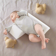 Soft, breathable fabric on anti-roll baby side sleep pillow. Gentle comfort & support for newborns, preventing flat head.