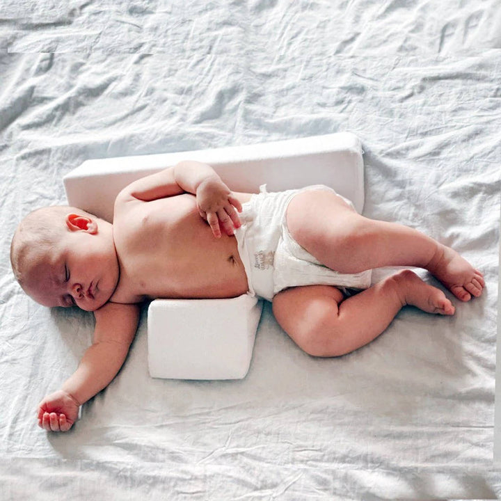 Flat head prevention infant support wedge, ensuring healthy baby head development.