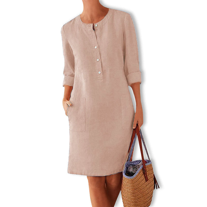 Overhead shot of Nika women's breathable summer dress, folded to show its vibrant color and cotton material.