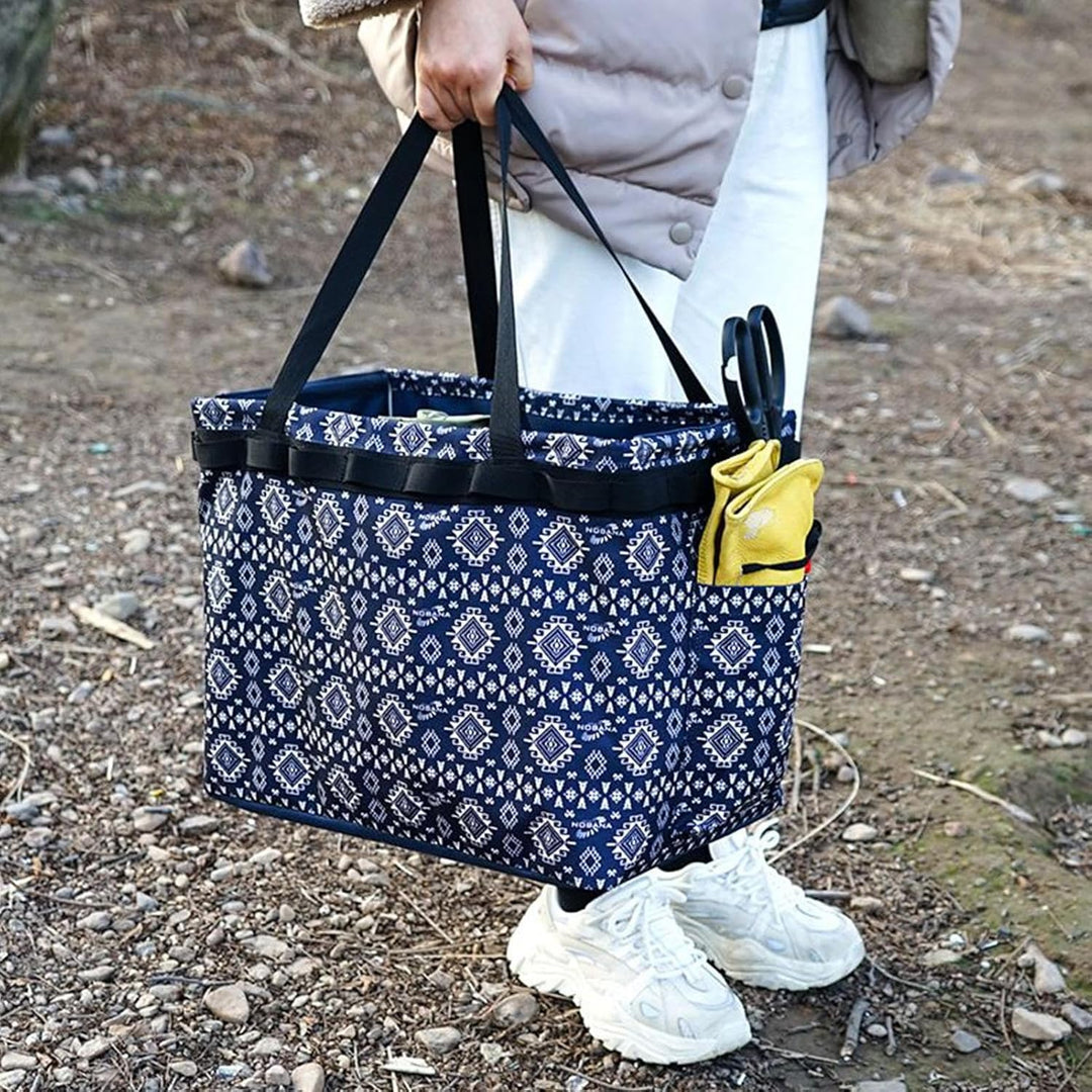 Unisex outdoor waterproof duffle bag, navy, being carried by a traveler