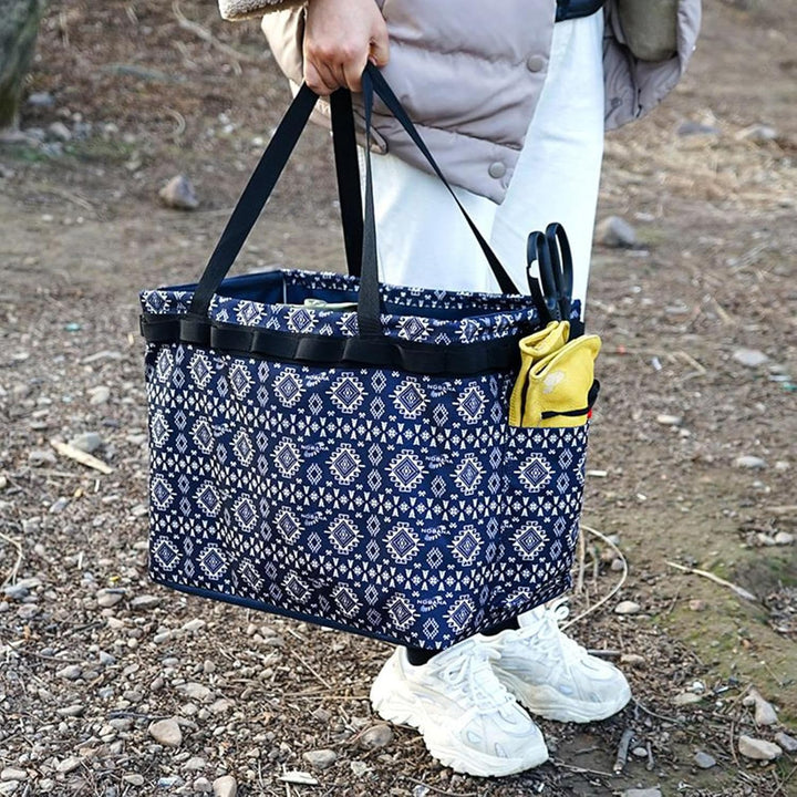 Unisex outdoor waterproof duffle bag, navy, being carried by a traveler