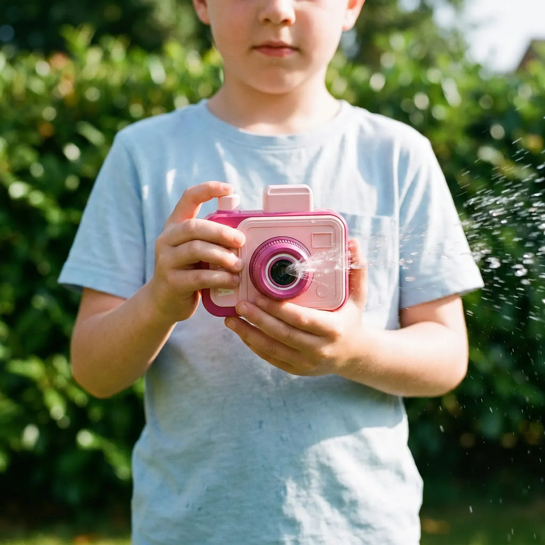 Novelty water squirt camera toy for kids, perfect for summer outdoor fun and playful pranks.