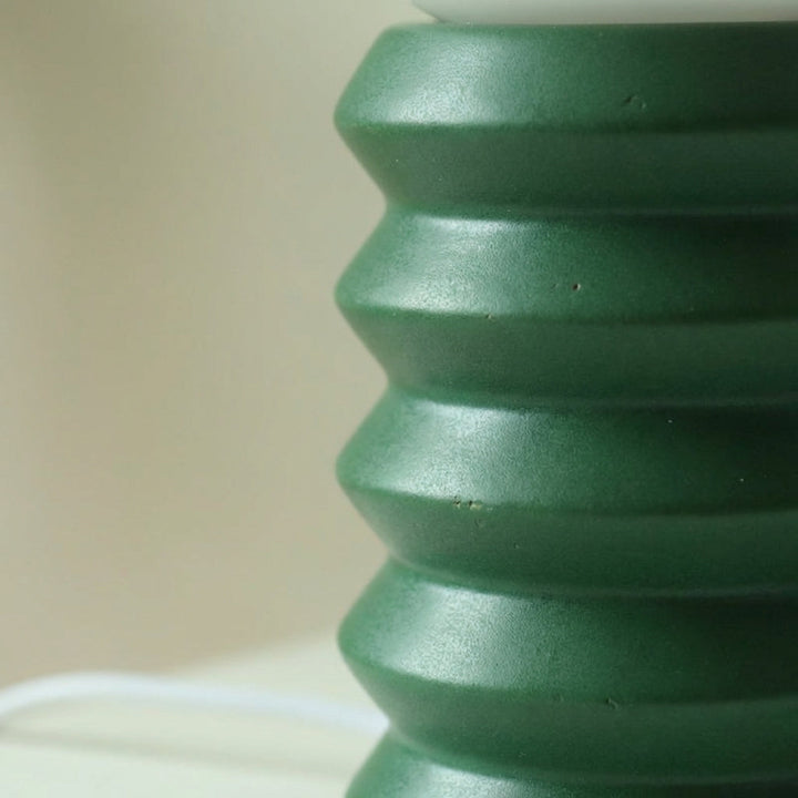 Stylish compact decorative table lamp, Orbisio, providing ambient lighting with its frosted glass globe