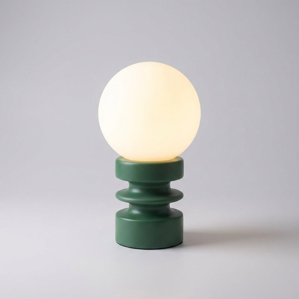 Close-up of Orbisio globe table lamp, highlighting the smooth frosted glass and the elegant wood base