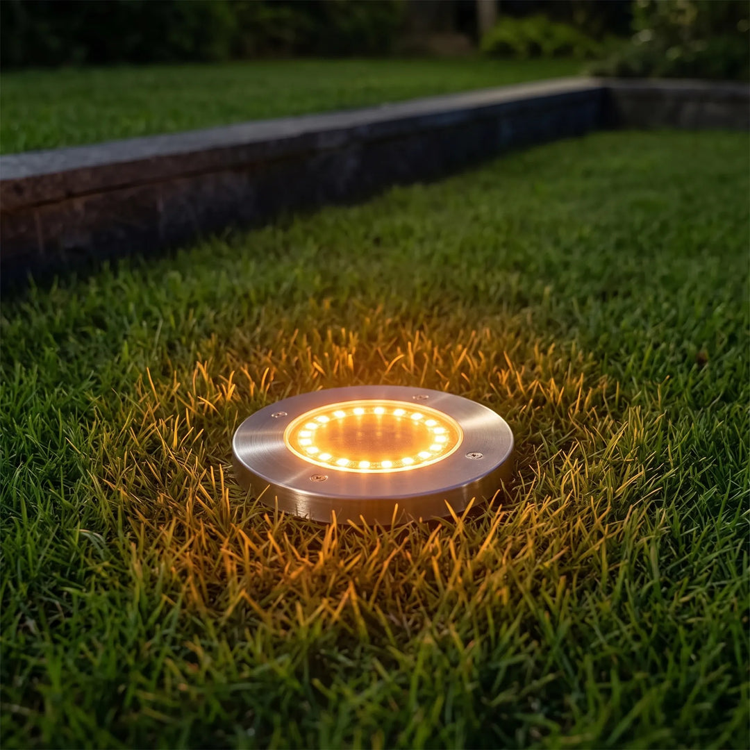 Outdoor solar ground lights illuminate garden paths, waterproof LED landscape lighting for yard decor.