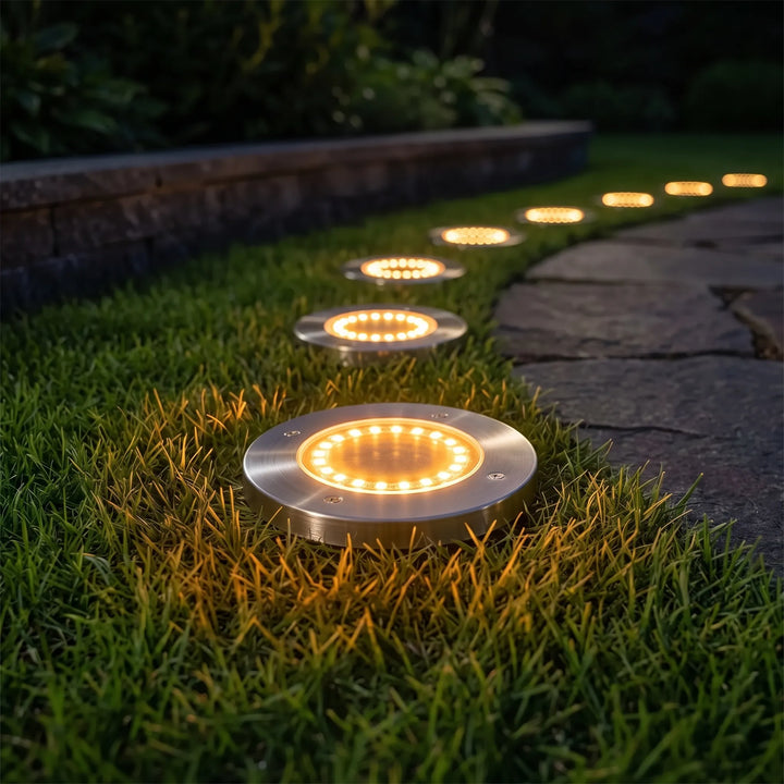 Set of 8 waterproof solar ground lights. Ideal for garden, pathway, and landscape lighting decor.