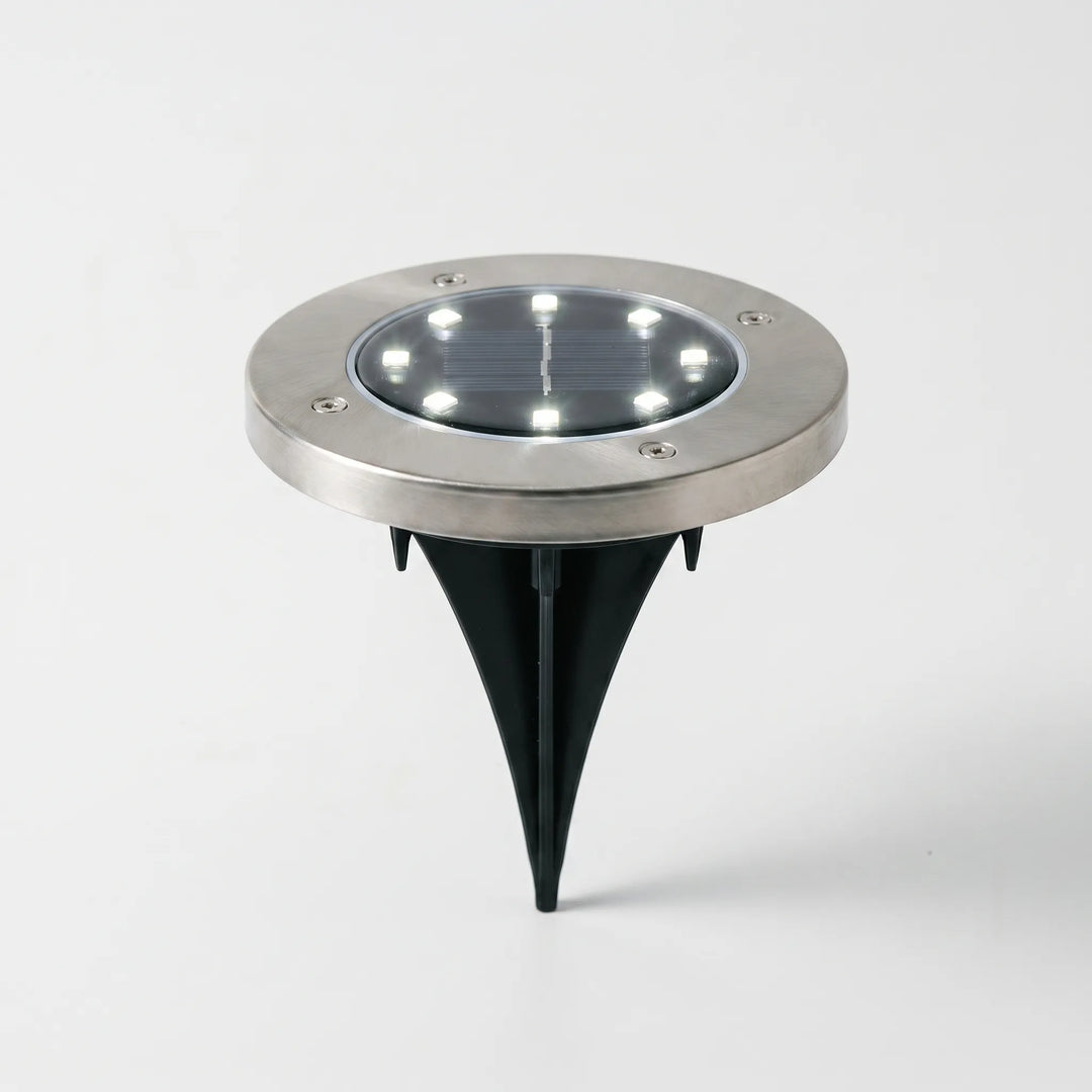 Weatherproof solar ground lights. LED pathway lighting enhances garden decor & outdoor ambiance.