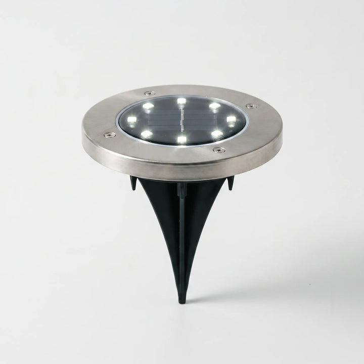 Weatherproof solar ground lights. LED pathway lighting enhances garden decor & outdoor ambiance.