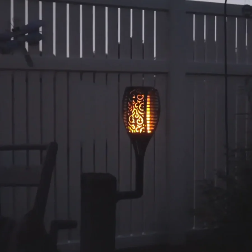 Decorative solar LED garden torch with dancing flame effect. Automatic, waterproof outdoor stake light for landscape.