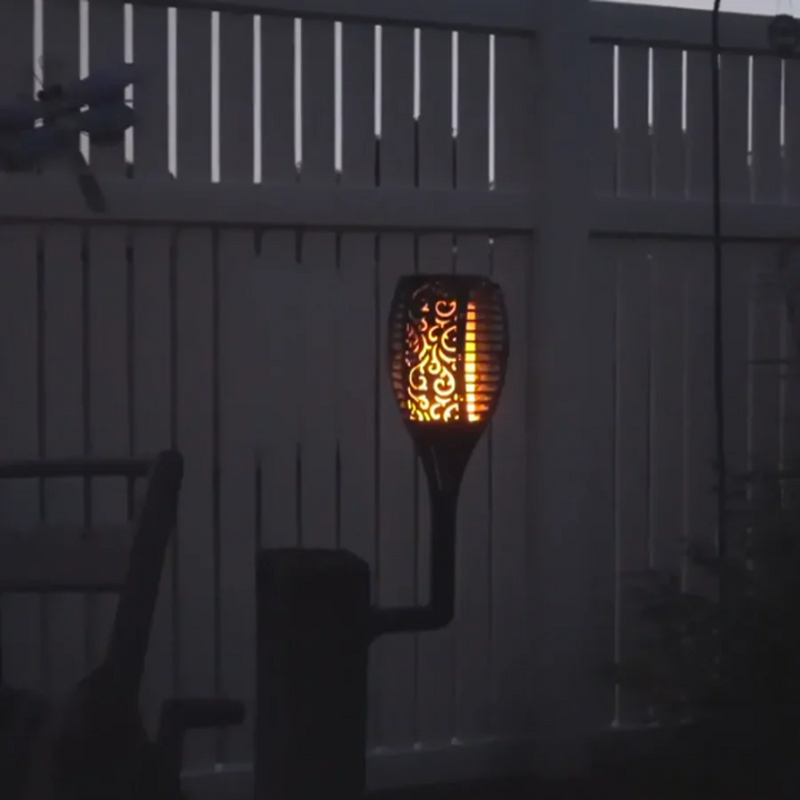 Decorative solar LED garden torch with dancing flame effect. Automatic, waterproof outdoor stake light for landscape.