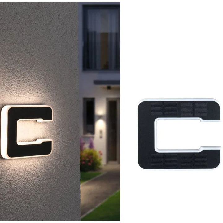 Solar-powered illuminated house number "12", clearly visible day or night, a smart outdoor lighting solution.