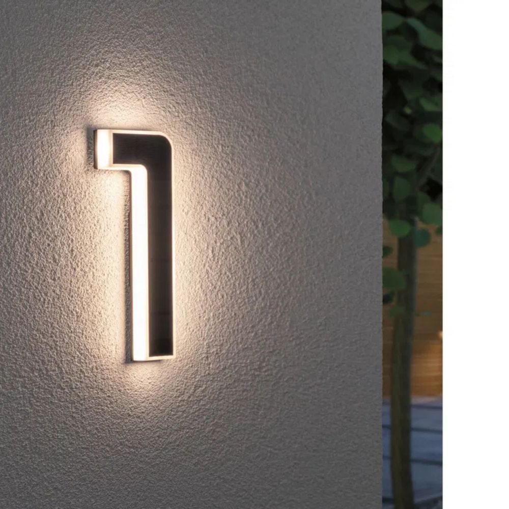 Modern illuminated address sign with solar power, showing bright LED numbers for home decor.