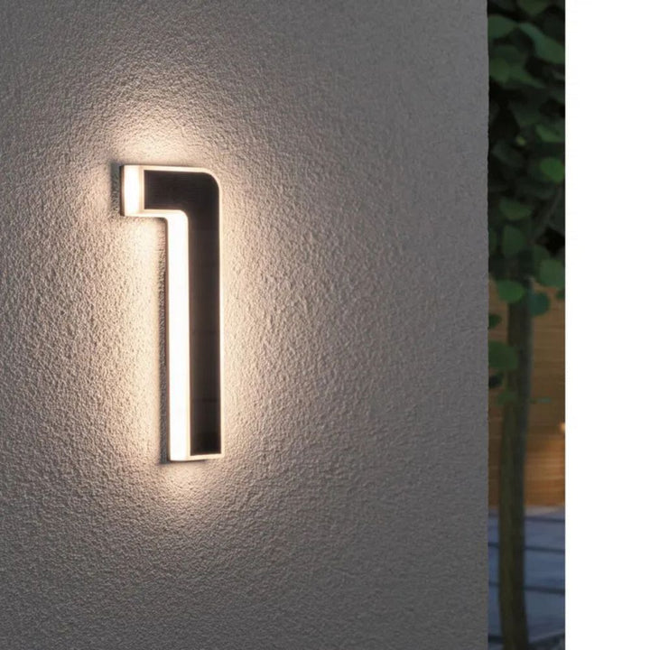 Modern illuminated address sign with solar power, showing bright LED numbers for home decor.
