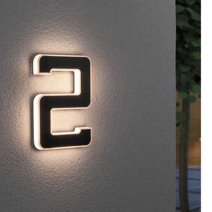 Weatherproof solar house number with bright LED lights, ensuring clear address visibility at night.