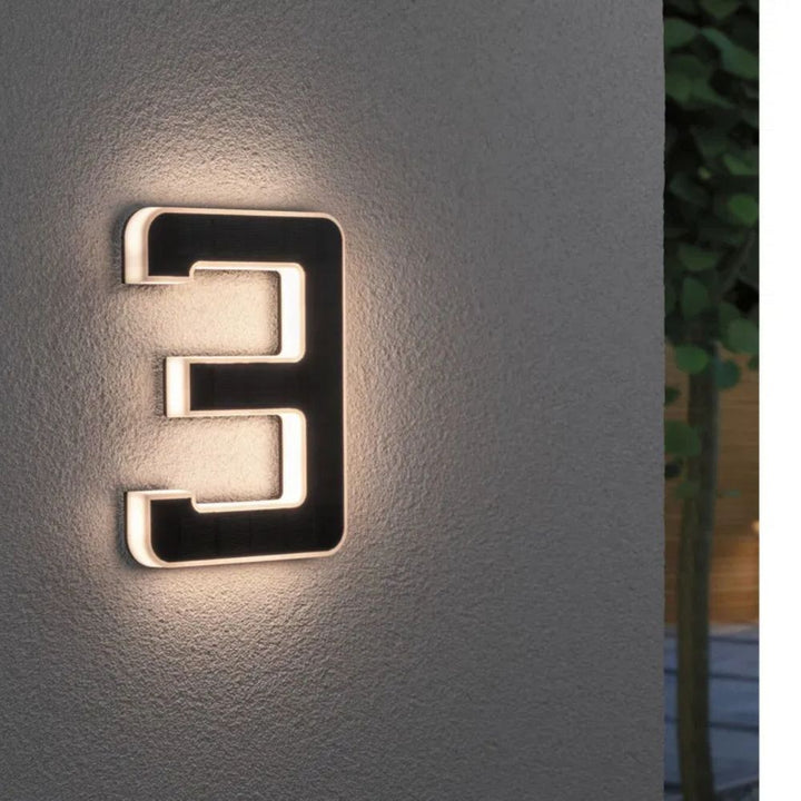 Close-up of a solar-powered LED house number, enhancing curb appeal and visibility.