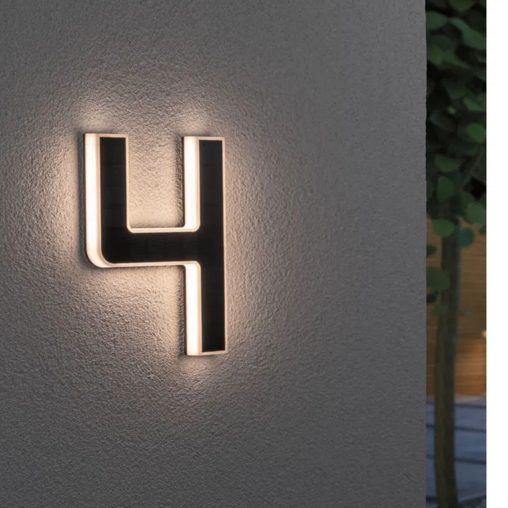 Stylish outdoor LED address sign, solar-charged for illuminated house numbers. Easy installation.