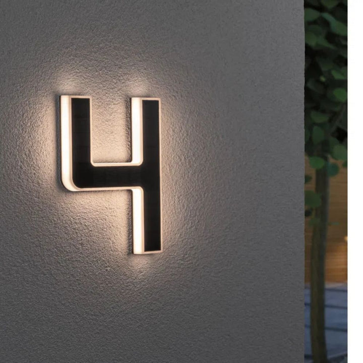 Stylish outdoor LED address sign, solar-charged for illuminated house numbers. Easy installation.