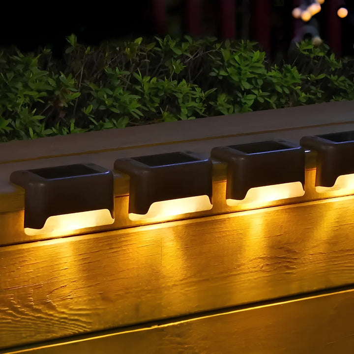 SoliStep Outdoor Solar LED Step Light casting a soft glow on garden foliage, perfect for ambient lighting