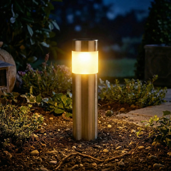 Solar-powered cylindrical path light, enhancing garden aesthetics with soft LED illumination.