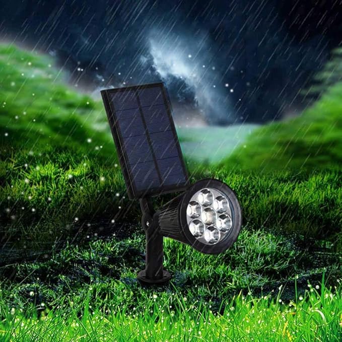 Durable outdoor solar spot light, black and IP65 waterproof, enhancing garden pathways with warm LED glow