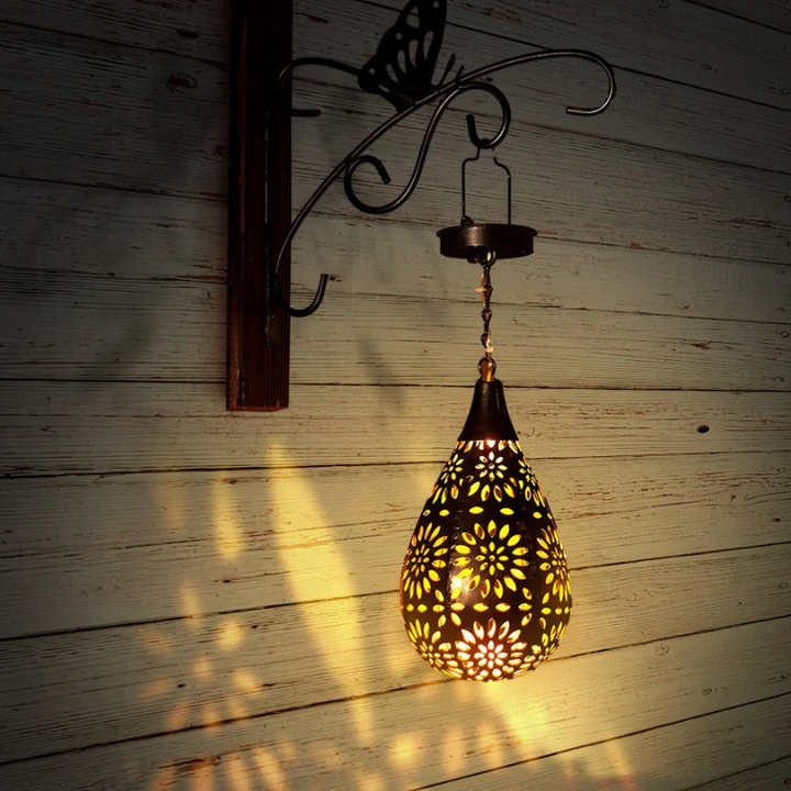 Outdoor solar-powered hanging lantern lamp. Perfect for garden, patio ambiance. Weatherproof & eco-friendly.