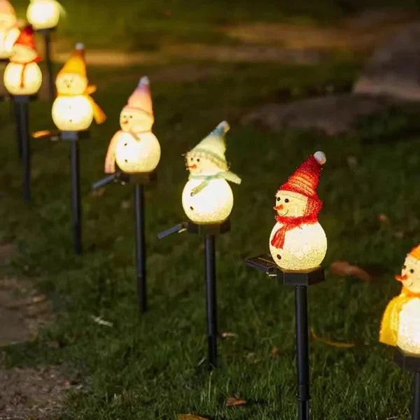 Bright solar-powered LED snowman light, enhancing outdoor Christmas decor with festive illumination.