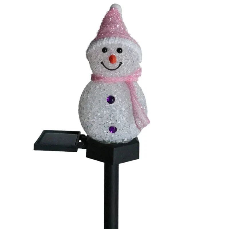 Illuminated solar snowman lamp, casting a warm glow on your outdoor Christmas garden at night.