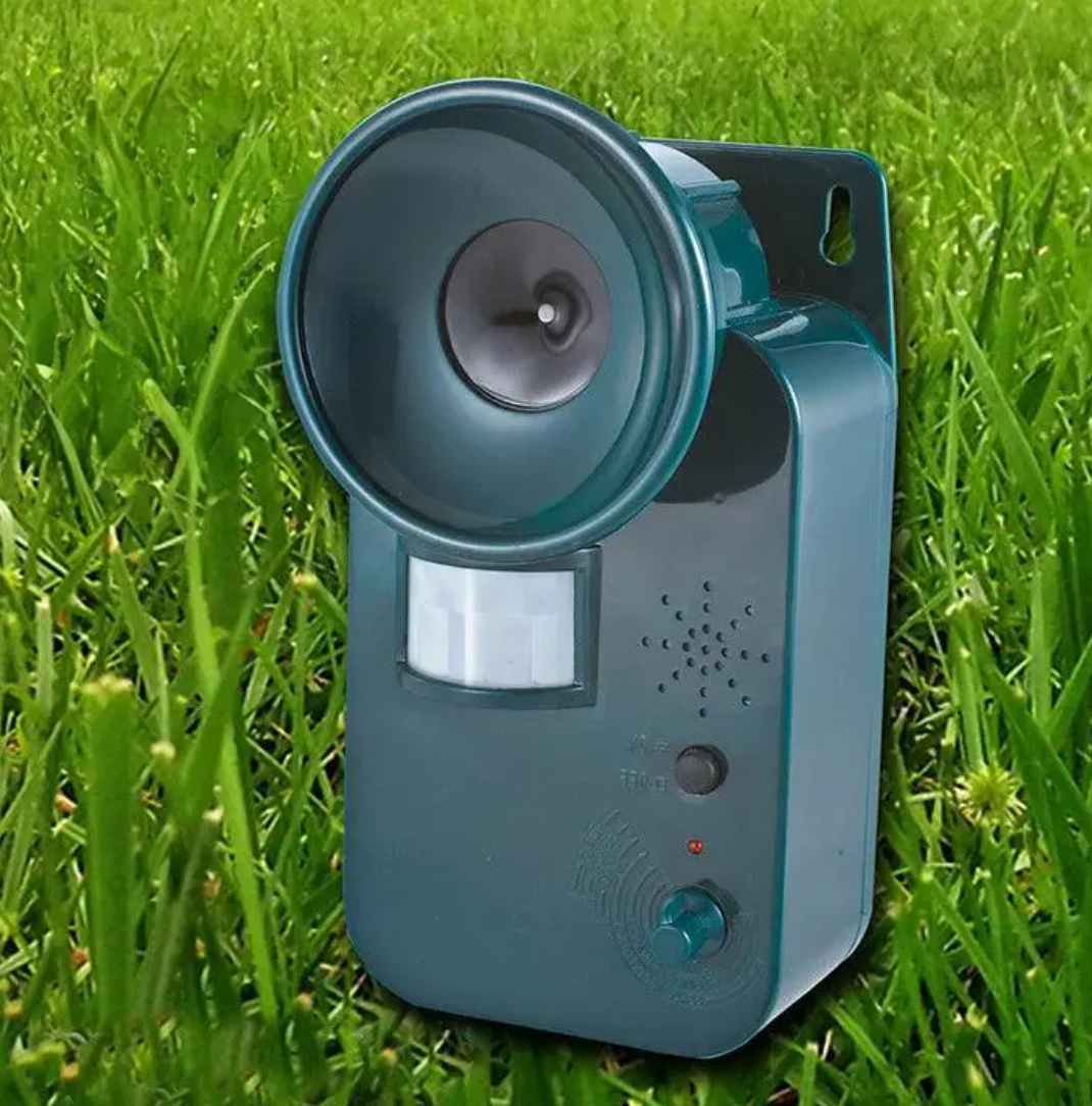 Outdoor ultrasonic cordless animal repeller with motion sensor for garden pest control.