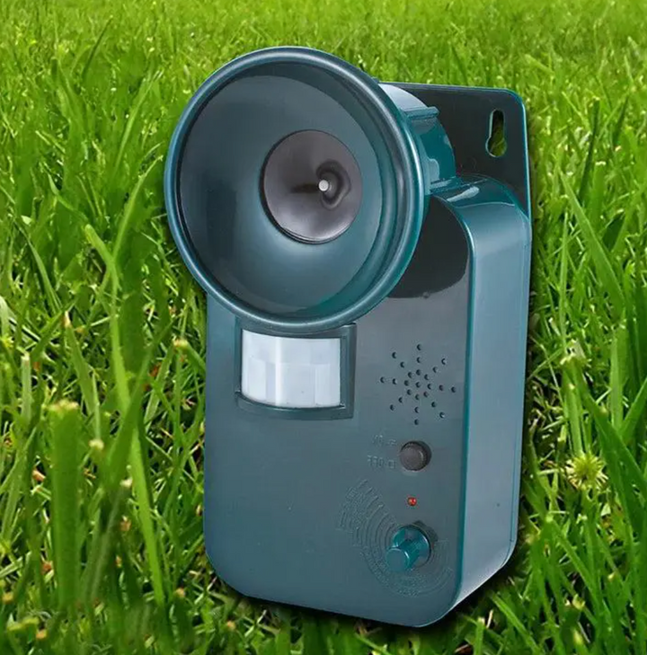 Outdoor ultrasonic cordless animal repeller with motion sensor for garden pest control.