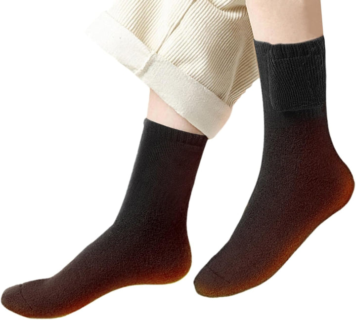 Pair of black USB rechargeable heated thermal socks, perfect for cold weather outdoor activities.