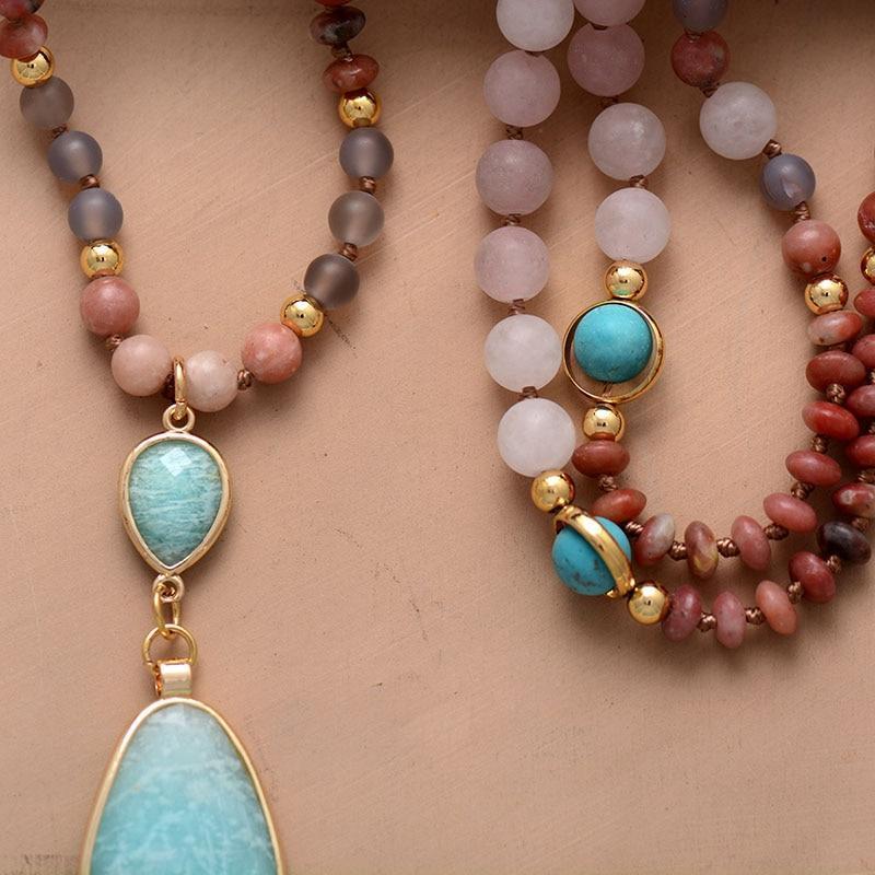 Close-up of a pastel gemstone mala necklace, showcasing rose quartz, jasper, and turquoise beads.