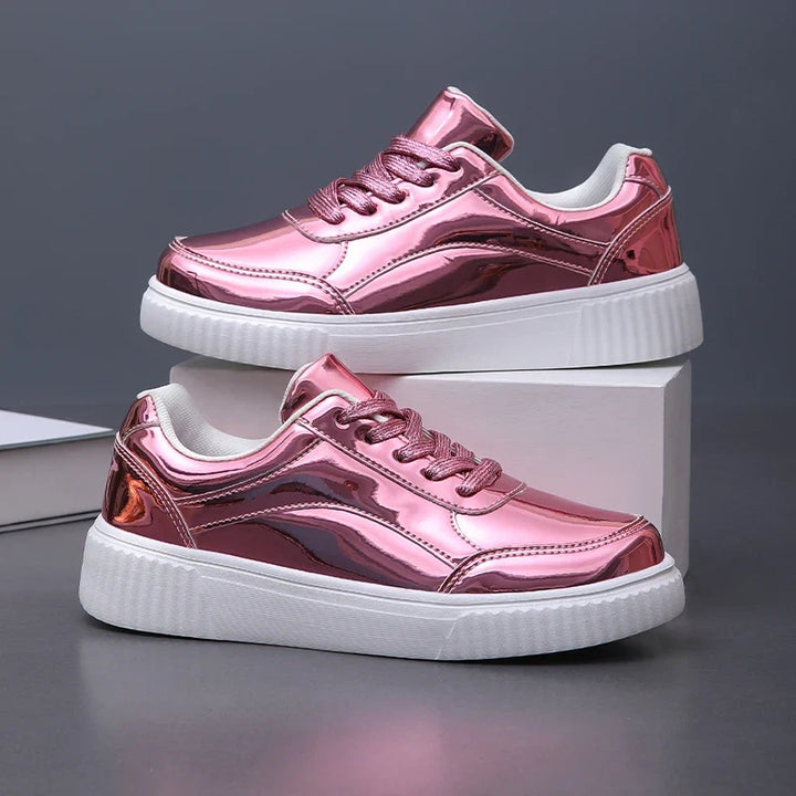 Gold women's glossy lace-up sneakers, stylish fashion footwear with an athletic edge for casual comfort.