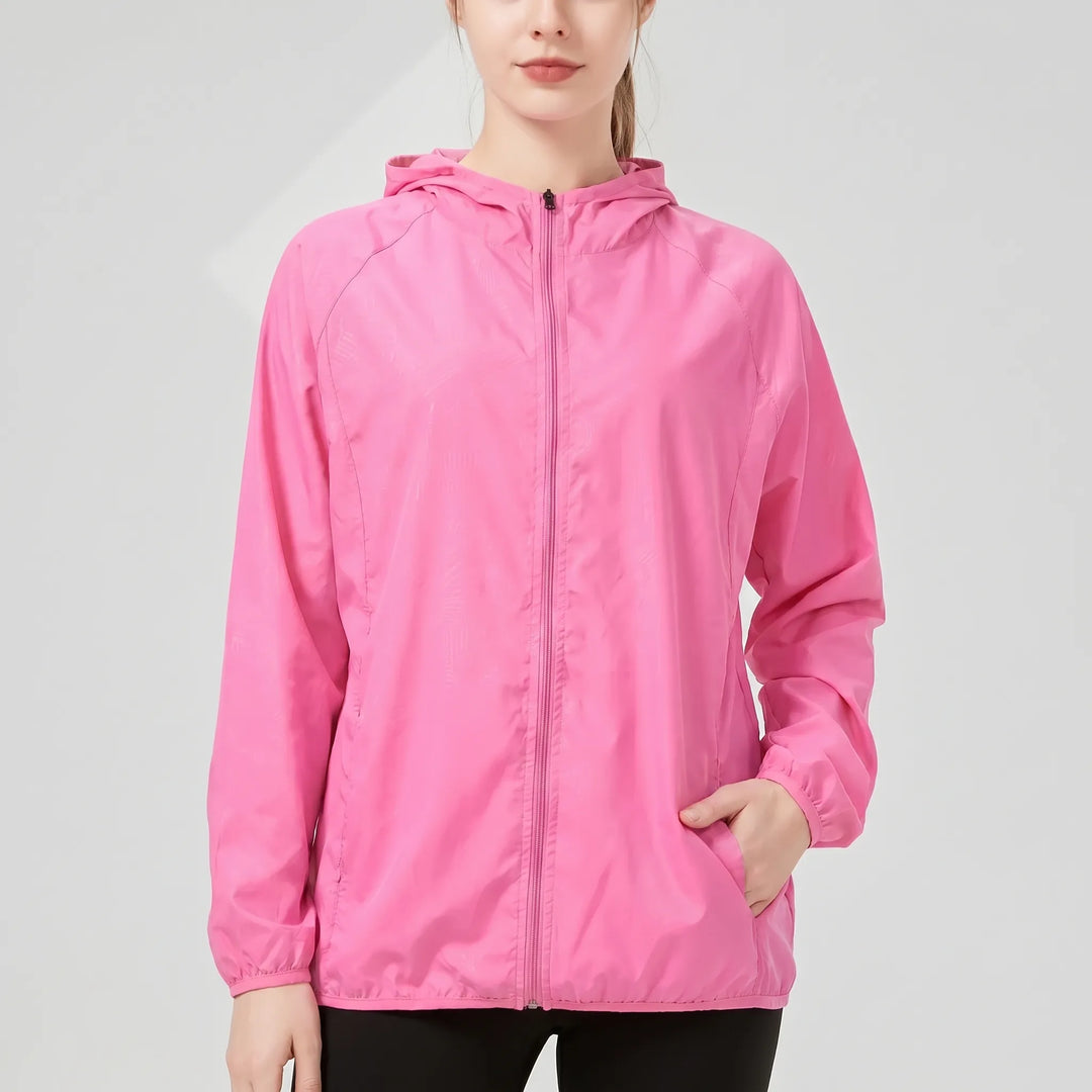 Green women's lightweight hooded windbreaker, ideal as a rain jacket for active outdoor and hiking adventures.