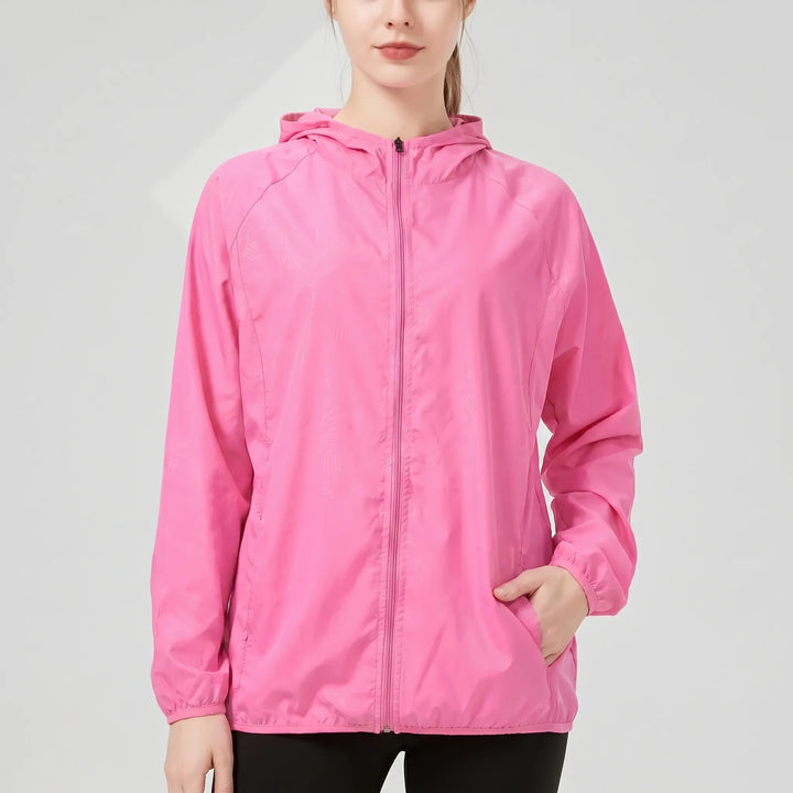 Green women's lightweight hooded windbreaker, ideal as a rain jacket for active outdoor and hiking adventures.