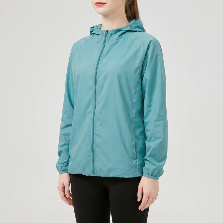 Yellow women's lightweight hooded outdoor performance jacket, ideal activewear for hiking, travel, and rain.