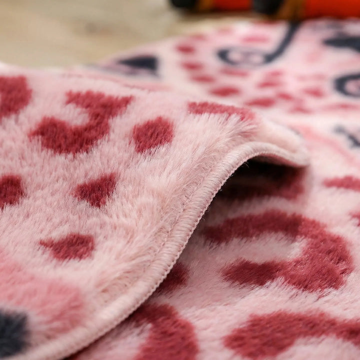Plush pink Flowique wavy animal print accent rug. Playful leopard floor decor for modern living rooms and kids' spaces.