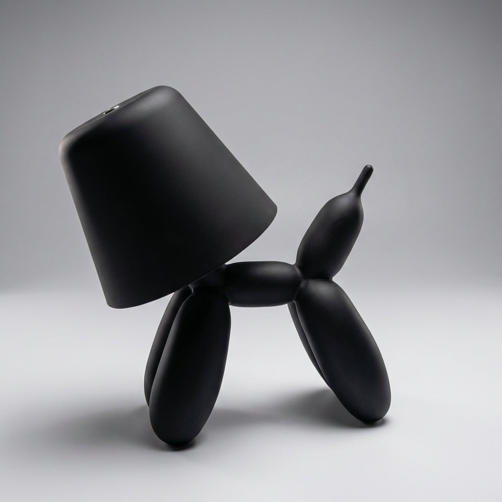 Close-up of a green Luminpup balloon dog lamp, highlighting its smooth finish and integrated LED for soft light.