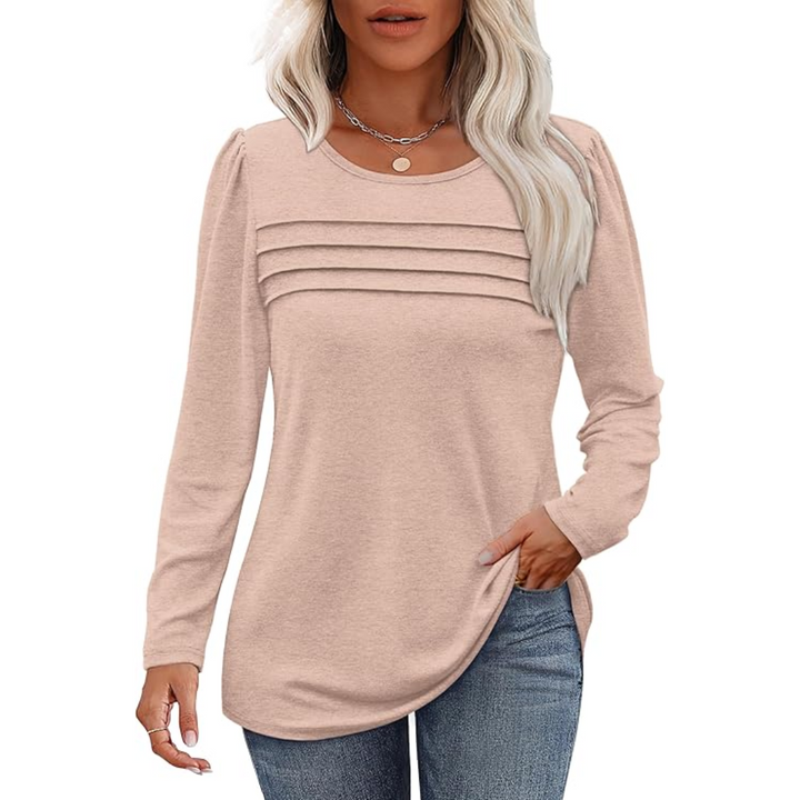 Close-up of the plissé pleats on a women's long sleeve tunic top, highlighting fabric detail