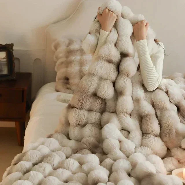 Close-up of soft anti-pilling faux fur throw blanket in a natural color, ideal for cozy evenings