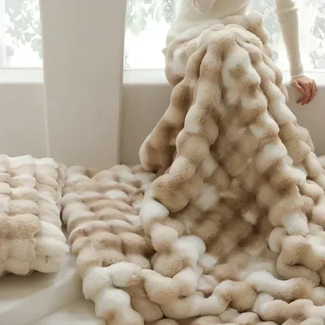 Soft faux fur blanket with a subtle sheen, a perfect home decor accent for cozy comfort