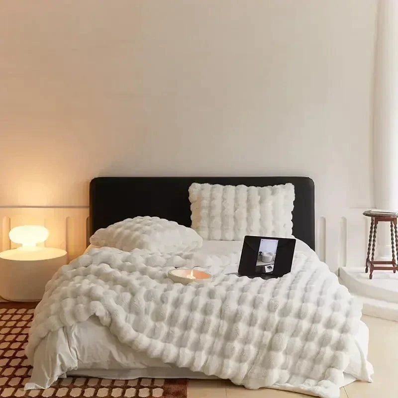 Textured cream faux fur blanket, showcasing its softness and inviting comfort for home styling
