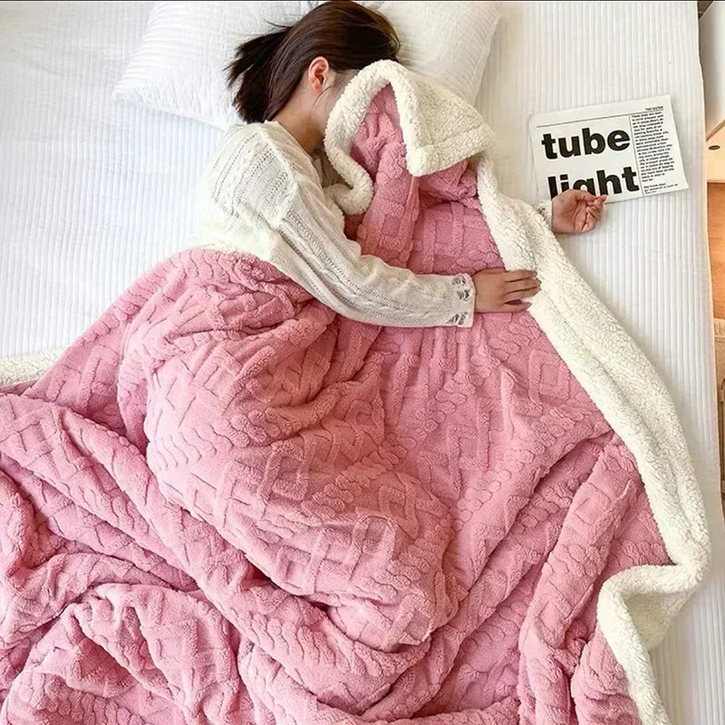 Comfortable bedding accessory: a thick, warm double-sided fleece and lambswool blanket draped over a sofa.