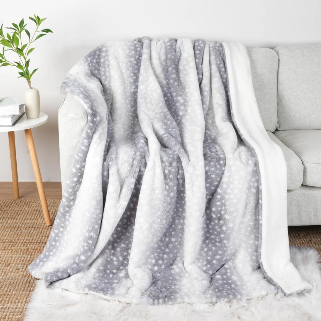Unisex plush faux fur deer throw blanket, reversible, warm & cozy. Perfect bedroom accent for comfort.