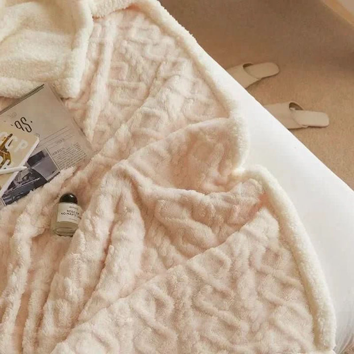 Luxurious plush lambswool blanket, soft & warm, ideal for a comfortable and cozy bedroom setting.
