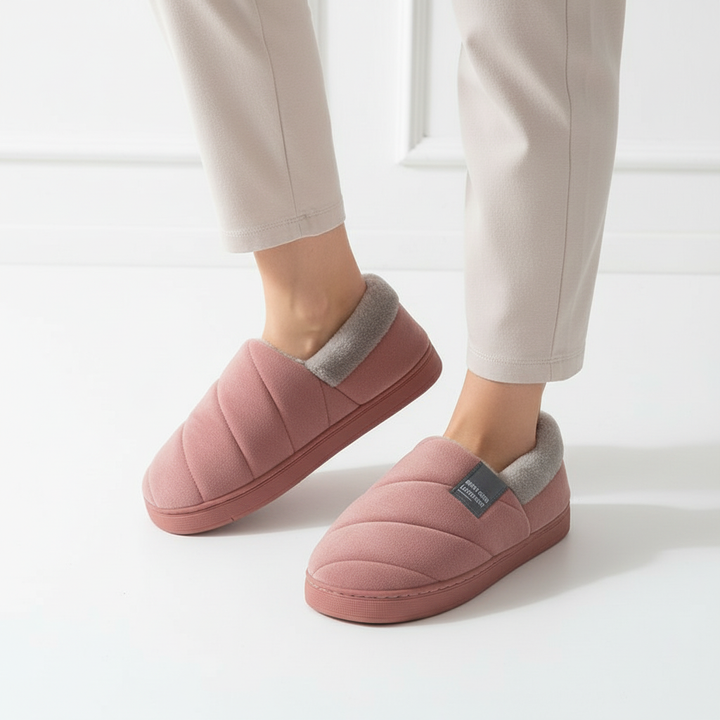 Side view of a woman's foot in a warm, fleece-lined slipper, showcasing the plush comfort