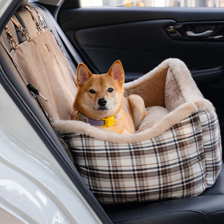 Washable plush car seat for small dogs, offering a secure & comfortable travel bed.
