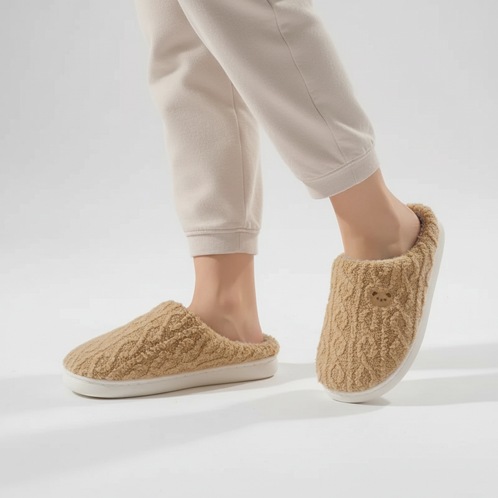 Soft peach women's slippers with fluffy exterior and warm fleece lining.